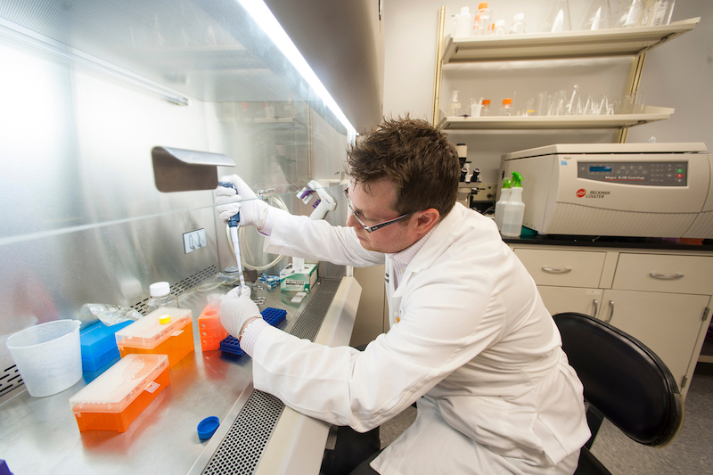 A scientist working at the bench in the Wet Lab LaunchPad located in the Dean Biomedical Research Building.